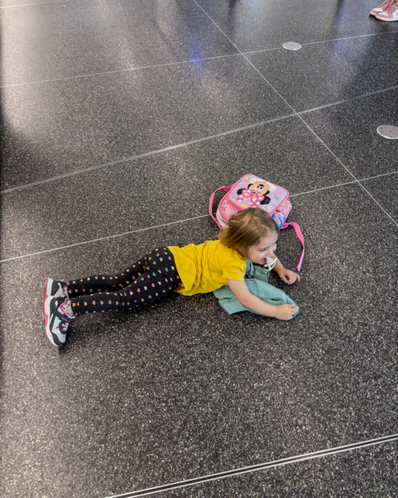 little girl on airport floor