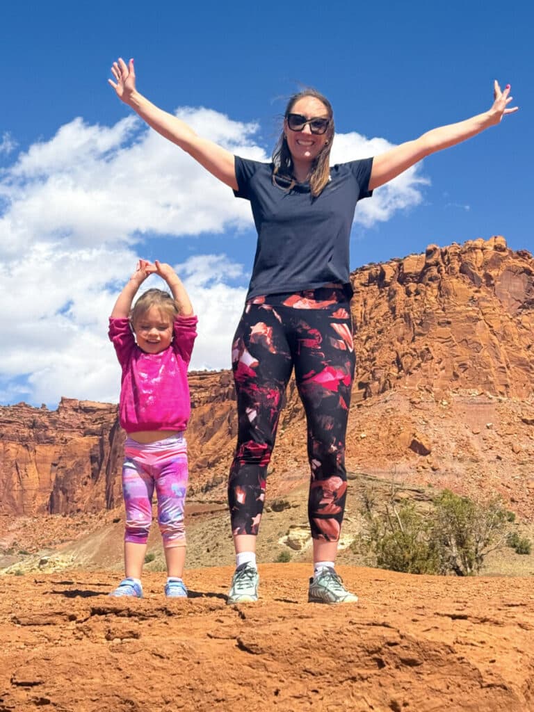 mom and daughter on rock near capitol reef national park