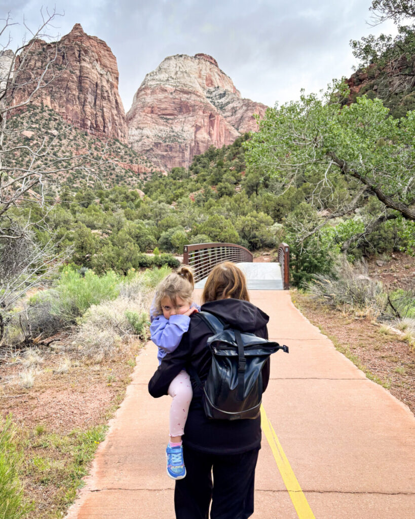 grandmother carrying toddler