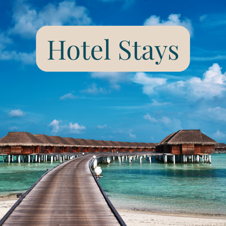Wooden boardwalk leading to overwater bungalows above turquoise water.