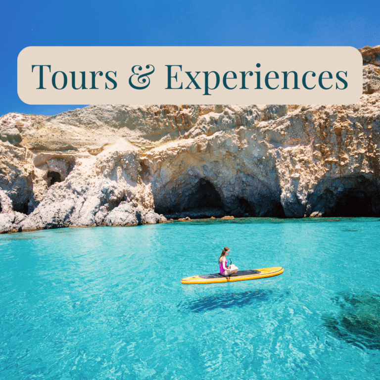 Tours & Experiences: Woman sitting on a paddleboard in turquoise water beside rocky sea caves.